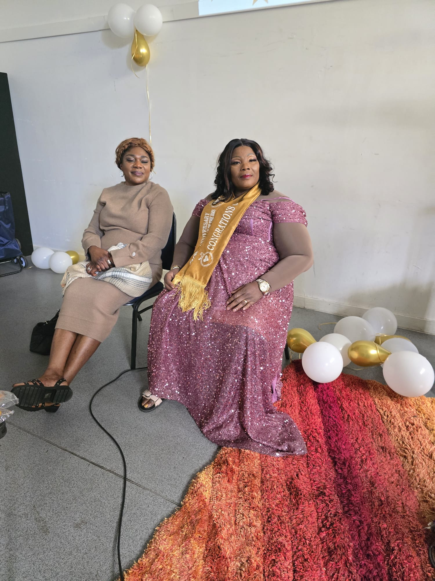 Special honoree wearing congratulations sash at the anniversary celebration