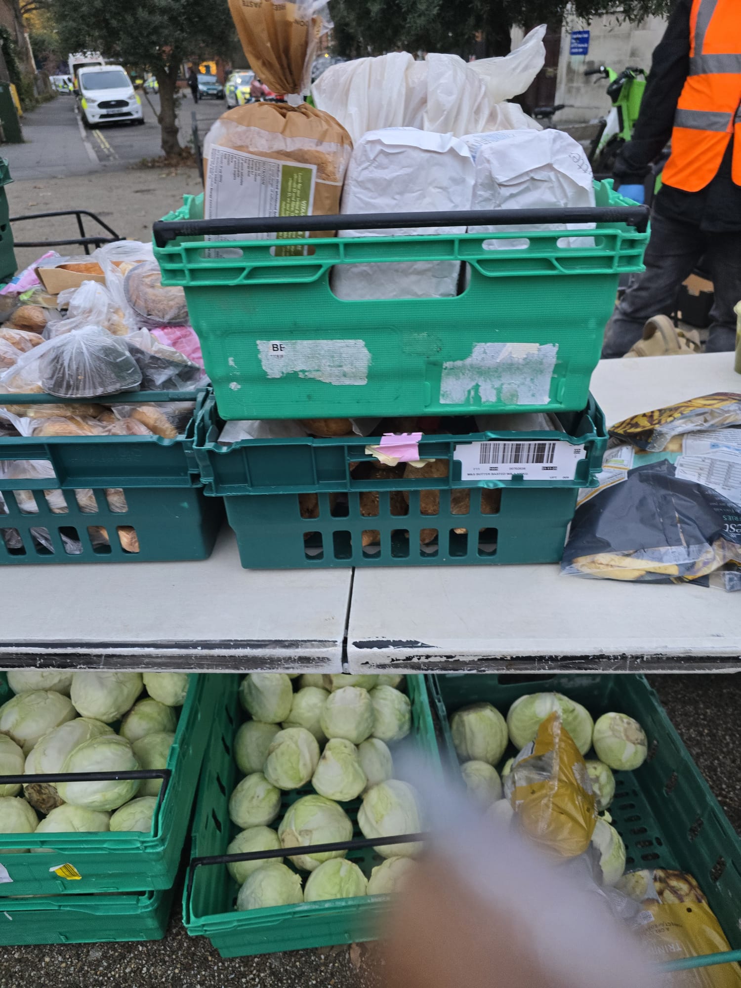 December 2025 Food Distribution - Fresh produce including cabbage and bread in delivery crates