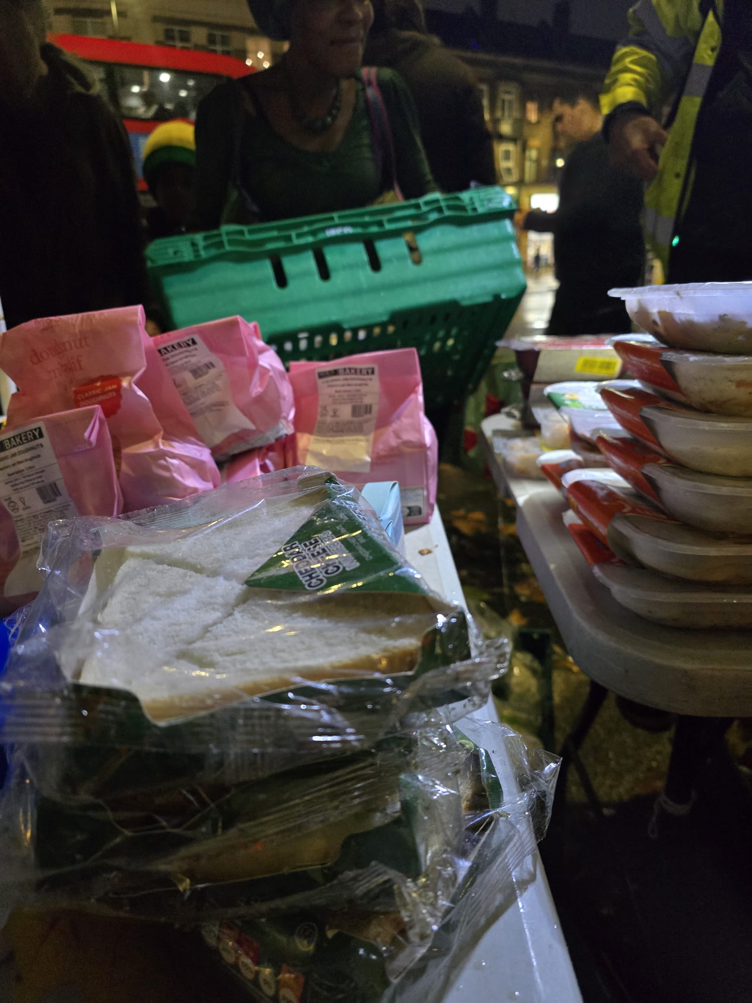 Complete street outreach table with meals, bakery items, and fresh produce
